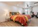 Bright bedroom with large windows, ceiling fan, a Peloton exercise bike, and a cozy bed with stylish decor at 406 W Coolidge St, Phoenix, AZ 85013