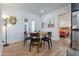 Inviting dining area with a round wooden table, black chairs, and access to the outdoors, filled with natural light at 406 W Coolidge St, Phoenix, AZ 85013