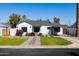 Charming home featuring a well-manicured lawn and a beautiful brick pathway to the front door at 406 W Coolidge St, Phoenix, AZ 85013