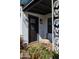 Stylish front entrance with a decorative door, accented by a colorful rug and vibrant flowers at 406 W Coolidge St, Phoenix, AZ 85013