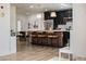 Stylish eat-in kitchen featuring black cabinetry, marble countertops, modern pendant lights, and wood grain floors at 406 W Coolidge St, Phoenix, AZ 85013