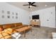 Well-appointed living room with a modern ceiling fan, a stylish cabinet, and a comfortable leather couch at 406 W Coolidge St, Phoenix, AZ 85013