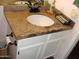 Bathroom sink with granite countertops, white cabinets, and updated fixtures at 4150 E Harvard Ave, Gilbert, AZ 85234