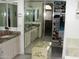 Bathroom featuring dual sinks, mirrors, white cabinets, and walk in closet at 4150 E Harvard Ave, Gilbert, AZ 85234