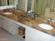 Bathroom featuring dual sinks, mirrors, and white cabinets with granite countertops at 4150 E Harvard Ave, Gilbert, AZ 85234