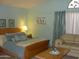 Comfortable bedroom with a sitting area, large bed, and decorative window at 4150 E Harvard Ave, Gilbert, AZ 85234