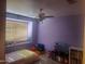 Bedroom with a ceiling fan, natural light, and play area at 4150 E Harvard Ave, Gilbert, AZ 85234