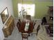 Elegant dining room with a chandelier, a mirror, and a wooden table at 4150 E Harvard Ave, Gilbert, AZ 85234
