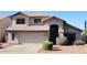 Charming two-story home featuring a front-facing garage and desert-style landscaping at 4150 E Harvard Ave, Gilbert, AZ 85234