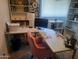 Well-lit home office with a spacious white desk and shelves at 4150 E Harvard Ave, Gilbert, AZ 85234