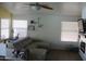 Bright living room with a ceiling fan, tile floors, and lots of natural light at 4150 E Harvard Ave, Gilbert, AZ 85234
