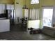 Open-concept living and kitchen area with tiled floors and stainless steel appliances at 4150 E Harvard Ave, Gilbert, AZ 85234