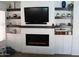 Modern fireplace in living room surrounded by white shelves and decorative elements at 4150 E Harvard Ave, Gilbert, AZ 85234