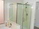 Bathroom featuring a glass shower door, white tile, and updated plumbing at 4150 E Harvard Ave, Gilbert, AZ 85234
