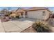 Attractive single-story home boasts a wide driveway and a neatly landscaped front yard at 42313 W Sparks Dr, Maricopa, AZ 85138