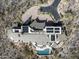 Aerial view of a luxury home with a long driveway, pool, solar panels, and desert landscaping at 42690 N 98Th Pl, Scottsdale, AZ 85262