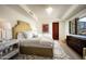 Cozy bedroom with a unique headboard, plush bedding, a statement light fixture, and hillside views at 42690 N 98Th Pl, Scottsdale, AZ 85262