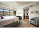 Bright and airy bedroom with a large window showcasing mountain views, a sitting area, and modern decor at 42690 N 98Th Pl, Scottsdale, AZ 85262