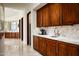 Butler's pantry features rich wood cabinetry, marble countertops, and convenient access to the main living areas at 42690 N 98Th Pl, Scottsdale, AZ 85262