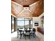 Contemporary dining room with a modern chandelier and mountain views from the floor-to-ceiling windows at 42690 N 98Th Pl, Scottsdale, AZ 85262