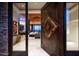 Modern grand entrance to living room featuring custom door with a beveled mirror design at 42690 N 98Th Pl, Scottsdale, AZ 85262