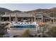Estate home features a sprawling pool deck with mountain views and an infinity pool at 42690 N 98Th Pl, Scottsdale, AZ 85262