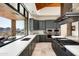 Gourmet kitchen with double oven and large island with bar seating adjacent to a window overlooking the mountains at 42690 N 98Th Pl, Scottsdale, AZ 85262