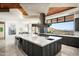 A bright and modern kitchen featuring an oversized island, stainless hood, and a scenic mountain view at 42690 N 98Th Pl, Scottsdale, AZ 85262