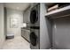 Well-organized laundry room with modern stacked washer/dryer and ample storage space at 42690 N 98Th Pl, Scottsdale, AZ 85262