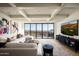 Comfortable living room with a large sofa, stylish decor, and panoramic views from the expansive windows at 42690 N 98Th Pl, Scottsdale, AZ 85262