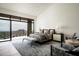 Serene main bedroom suite with scenic views, high ceilings, and access to a private balcony at 42690 N 98Th Pl, Scottsdale, AZ 85262