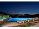 Inviting outdoor space featuring a sparkling pool, spa, lounge chairs, and city views at 42690 N 98Th Pl, Scottsdale, AZ 85262