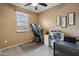 Cozy bedroom featuring a ceiling fan, bright window, and a treadmill for convenient at-home workouts at 4769 E Thunderheart Trl # 101, Gilbert, AZ 85297