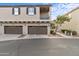 Exterior of two-story townhome featuring attached two-car garages and neutral color palette at 4769 E Thunderheart Trl # 101, Gilbert, AZ 85297