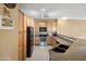 Well-lit kitchen featuring wooden cabinets, stainless steel appliances and countertop seating at 4769 E Thunderheart Trl # 101, Gilbert, AZ 85297