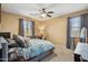 Cozy bedroom featuring natural light, ceiling fan, and dresser at 4769 E Thunderheart Trl # 101, Gilbert, AZ 85297