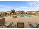 Community pool with lounge chairs, tables, and seating areas at 4769 E Thunderheart Trl # 101, Gilbert, AZ 85297