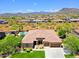 Expansive aerial view showcasing a private pool and a spacious backyard in a desert community setting at 6044 E Hodges St, Cave Creek, AZ 85331