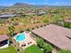 Spacious backyard with a pool, hot tub, lounge area, and lush landscaping in a serene desert setting at 6044 E Hodges St, Cave Creek, AZ 85331