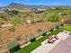 Expansive desert property featuring a pool, patio, and artificial turf amid natural desert landscaping at 6044 E Hodges St, Cave Creek, AZ 85331