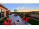 Outdoor living area featuring a fire pit, lounge chairs, and well-manicured desert landscaping at 6044 E Hodges St, Cave Creek, AZ 85331