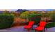 Relaxing backyard featuring lounge chairs, a side table, and picturesque mountain views in the distance at 6044 E Hodges St, Cave Creek, AZ 85331