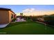Spacious backyard with putting green, fire pit area, and desert landscaping at 6044 E Hodges St, Cave Creek, AZ 85331