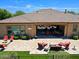 Stunning backyard with a covered patio, fire pit, outdoor seating, and lush landscaping, ideal for relaxing at 6044 E Hodges St, Cave Creek, AZ 85331