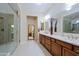 Modern bathroom featuring double sinks, large mirrors, and a glass enclosed shower at 6044 E Hodges St, Cave Creek, AZ 85331