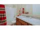 Bathroom with a red and brown striped shower curtain, granite counters, and bath accessories at 6044 E Hodges St, Cave Creek, AZ 85331