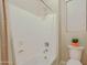 A full, all-white bath tub and shower with updated fixtures in a neutral bathroom setting at 6044 E Hodges St, Cave Creek, AZ 85331
