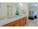 Bright bathroom with granite counters, dual sinks, and a view into an adjacent bedroom at 6044 E Hodges St, Cave Creek, AZ 85331