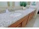 Bright bathroom featuring a granite countertop, double sinks and updated fixtures at 6044 E Hodges St, Cave Creek, AZ 85331