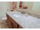 Bathroom vanity featuring a granite countertop, sink, and modern faucet at 6044 E Hodges St, Cave Creek, AZ 85331